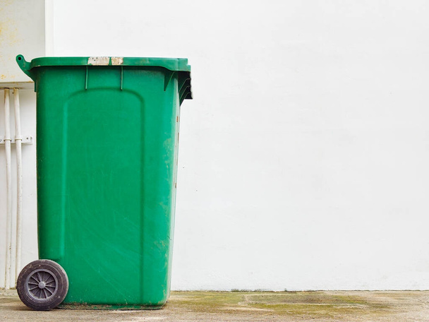 A green color waste bin isolated on white background - Foto, immagini