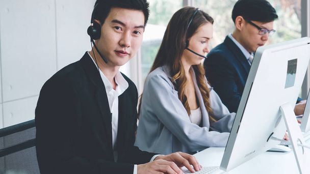 Business people wearing headset working in office - Фото, зображення