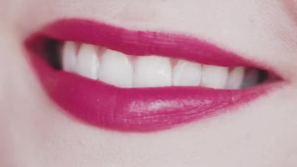Lippen mit rosa Lippenstift und weißen Zähnen, die lächeln, Makro-Nahaufnahme eines glücklichen weiblichen Lächelns, Zahngesundheit und Schönheits-Make-up - Filmmaterial, Video