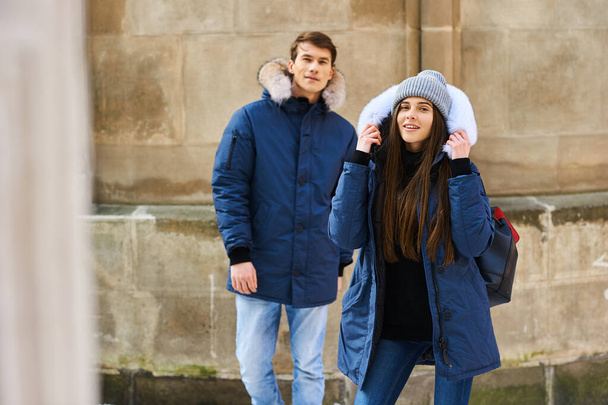 A trendy young couple walks in the city at christmastime - Fotoğraf, Görsel