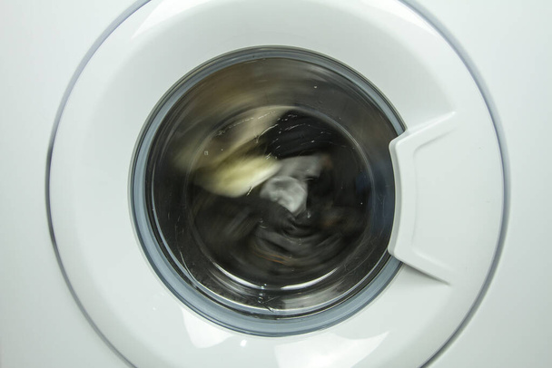 close up front view of a washing machine door in operation - Foto, afbeelding