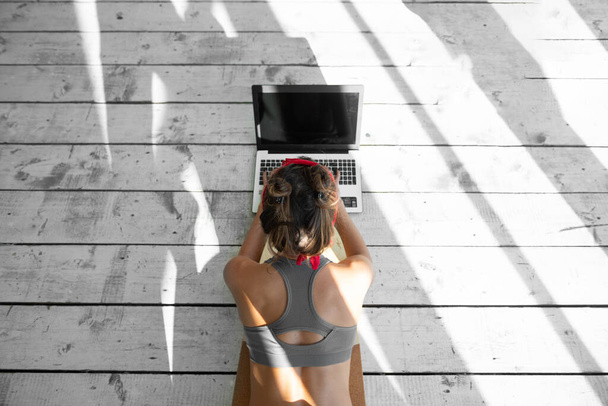 Woman doing online yoga classes indoors - Foto, Bild
