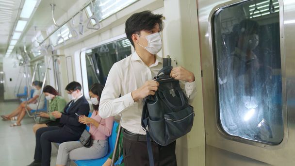 Crowd of people wearing face mask on a crowded public subway train travel - Foto, imagen