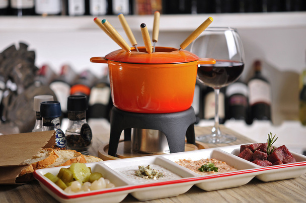 Fondue with appetizer and red wine - Фото, зображення