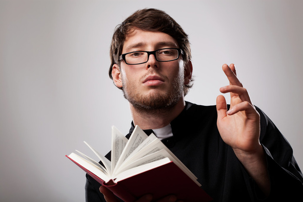 Priest with Holy Bible - 写真・画像