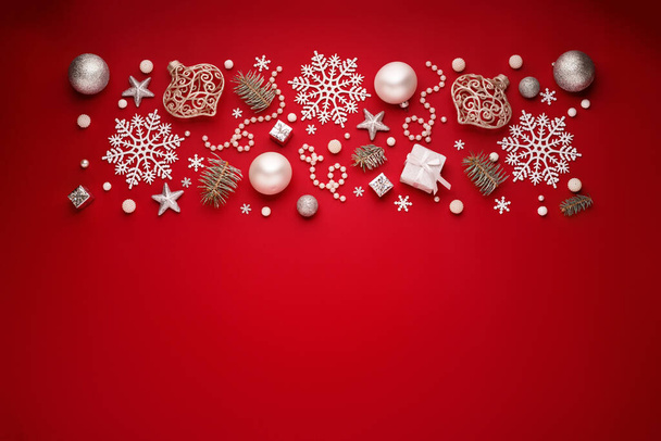 Christmas border of white decorations on red copy space background. - Photo, Image