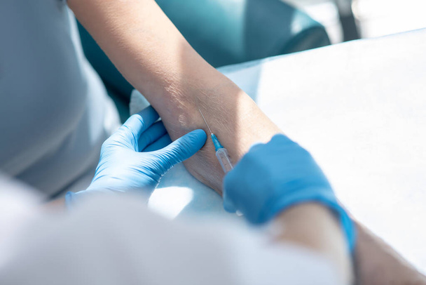 Close up picture of human hands making intravenous injection - Φωτογραφία, εικόνα