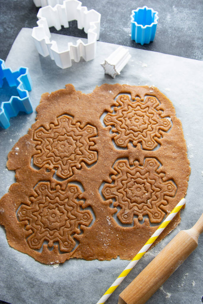 Christmas baking cookies snowflakes shape. Raw dough, cookie cutters, rolling pin. Abstract winter food background. - Valokuva, kuva
