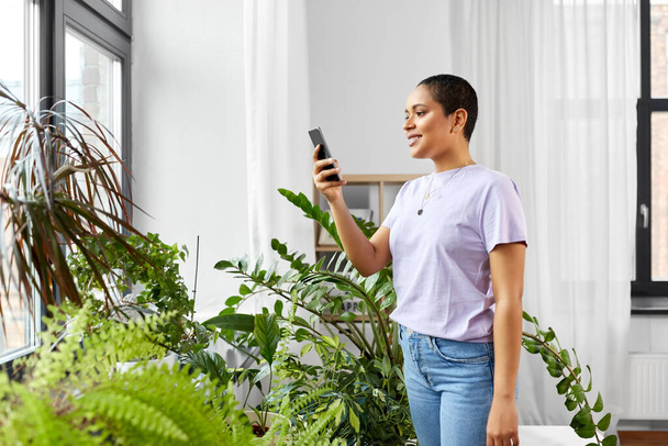 african american woman with smartphone at home - Photo, Image