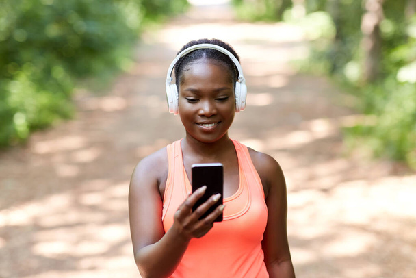 african american woman with headphones and phone - Foto, Imagen