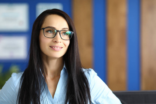 Portrait of smiling businesswoman with glasses in office. - Photo, image