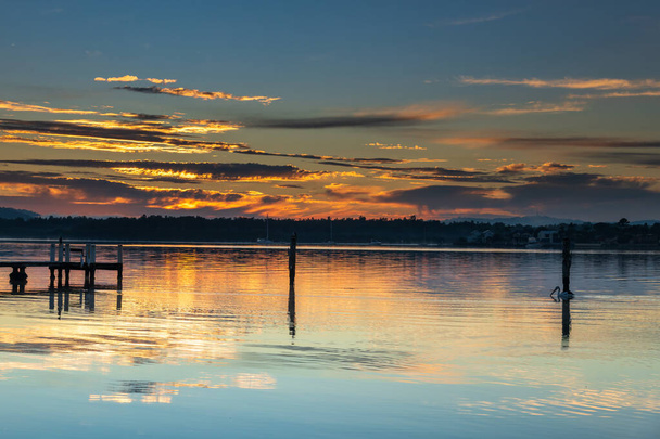 Sunrise waterscape with high cloud and reflections at Woy Woy Waterfront on the Central Coast, NSW, Australia. - Fotoğraf, Görsel