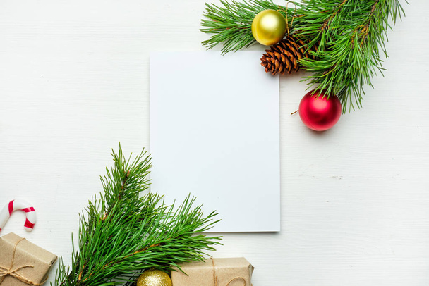 Paper sheet for copy space with top view on wooden background with new year gifts. - 写真・画像