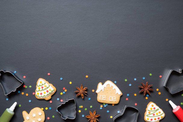 Forms for cooking and christmas cookies on black background with copy space. - Фото, изображение