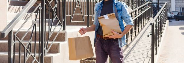 Delivery man delivering food to home - online grocery shopping service concept - 写真・画像