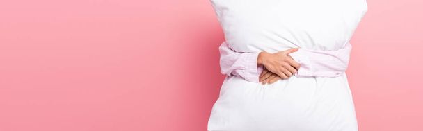 Cropped view of woman embracing pillow on pink background, banner  - Foto, Imagem