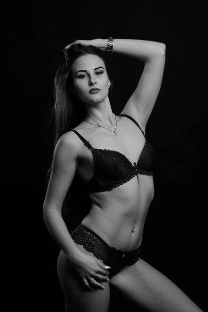 Beautiful sexy woman in blue underwear on a dark background, perfect female body, studio shot - Foto, Imagem