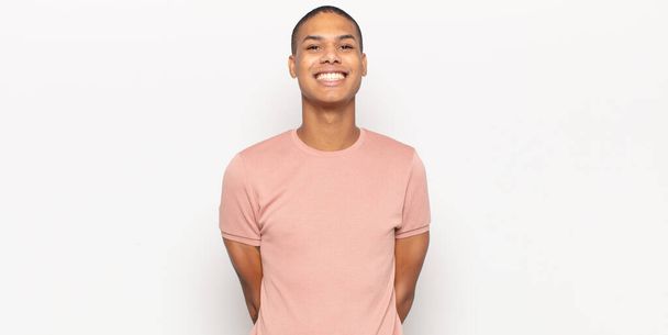young black man looking happy and goofy with a broad, fun, loony smile and eyes wide open - Foto, afbeelding