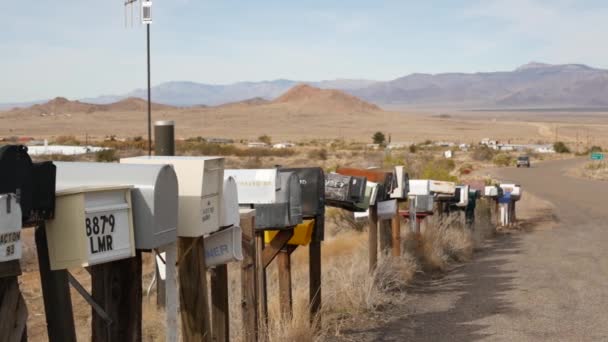 Reihe von Oldtimer-Briefkästen an einer Straßenkreuzung in der trockenen Arisona Wüste, USA. Postbriefkästen am Straßenrand der touristischen Route 66. Adresse auf altmodischem nostalgischem Metall-Grunge-Briefkasten auf Säule - Filmmaterial, Video