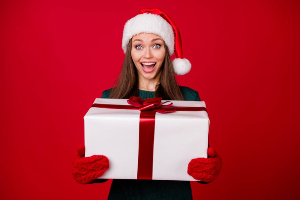 Portrait of her she nice attractive charming pretty glad cheerful cheery girl holding in hands big giftbox having fun isolated over bright vivid shine vibrant red color background - Foto, Bild