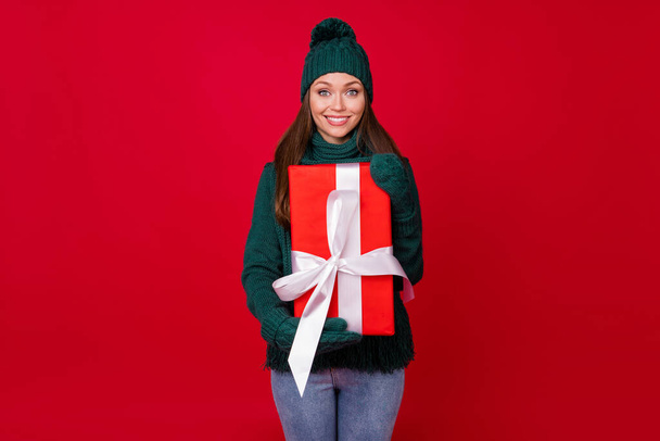 Portrait of her she nice attractive lovely cute cheerful cheery girl holding in hands big giftbox festal day occasion isolated over bright vivid shine vibrant red color background - Foto, afbeelding