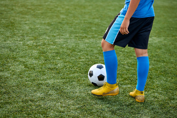 kid boy kicking soccer ball on sports field - Foto, Bild