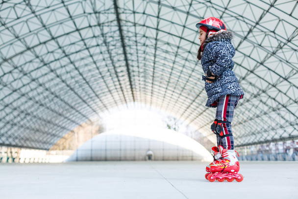 little girl rollerblading on roller rink - Photo, Image