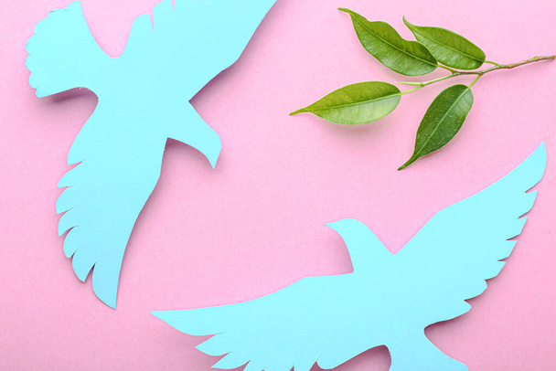 Paper doves and olive branch on color background. International Day of Peace - Photo, Image