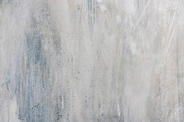 A closeup of an abstract background in light gray and blue color with scratches and scuffs. - Foto, afbeelding