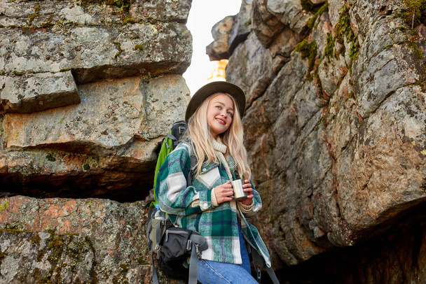 beautiful caucasian blonde female is travelling alone on mountains - Photo, Image