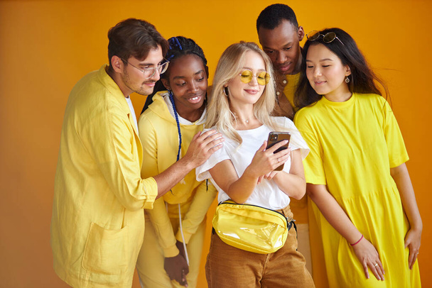 stylish international group of young people take selfie isolated on yellow background - Foto, afbeelding