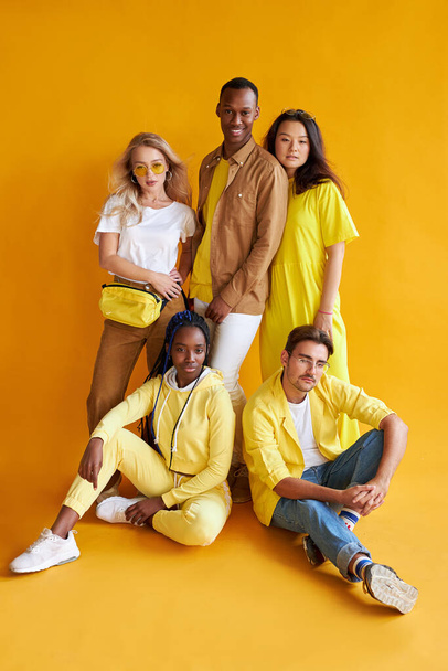 students from different countries in studio with yellow background - Фото, зображення