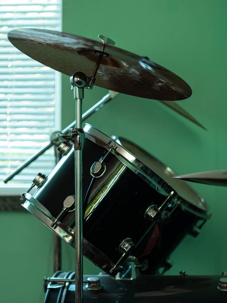 Black drum kit close-up. Musician set with mix of drums in studio. Musical instruments devices for drumming performance. Low key, dark and moody rock metal music style. - Fotó, kép