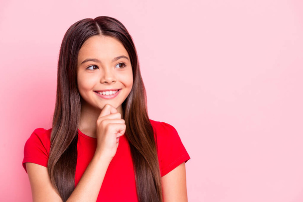 Photo of lovely sweet pensive funny small lady long hairstyle arm chin beaming shiny smiling dreamy face playful sly look empty space wear red t-shirt isolated pink color background - Φωτογραφία, εικόνα