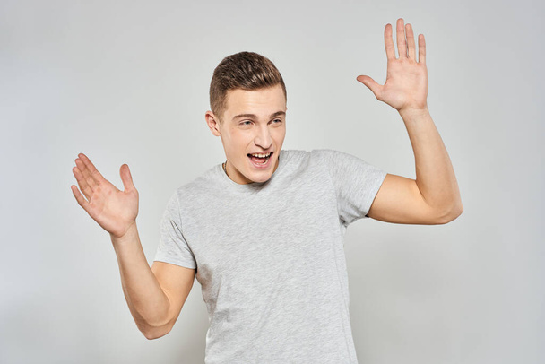 handsome man in light t-shirt cropped view emotion studio isolated background - Фото, зображення
