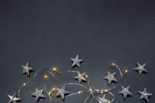 Nieuwjaar grijze fotofoon met kerstslinger en sterren - Foto, afbeelding
