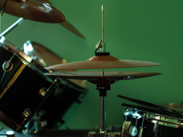 Black drum kit close-up. Musician set with mix of drums in studio. Musical instruments devices for drumming performance. Low key, dark and moody rock metal music style. Selective focus on cymbals. - Photo, Image