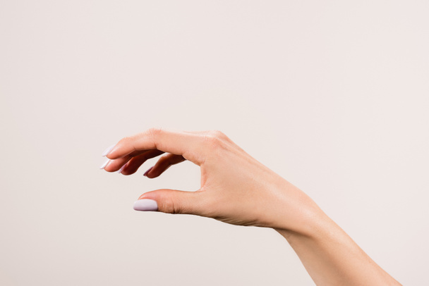 cropped view of female hand isolated on grey - Foto, Bild