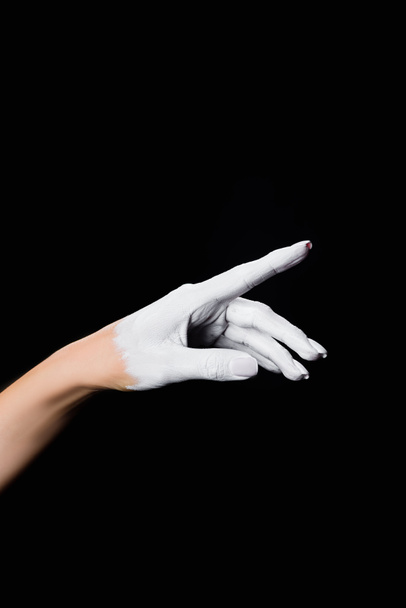 partial view of white painted hand isolated on black - Foto, Imagem