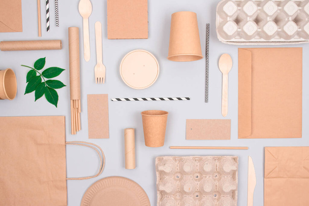 Flat lay composition with eco-friendly tableware - kraft paper food packaging on light grey background. Street food paper packaging - cups, plates, straws, containers and paper bags. Mockup - Valokuva, kuva