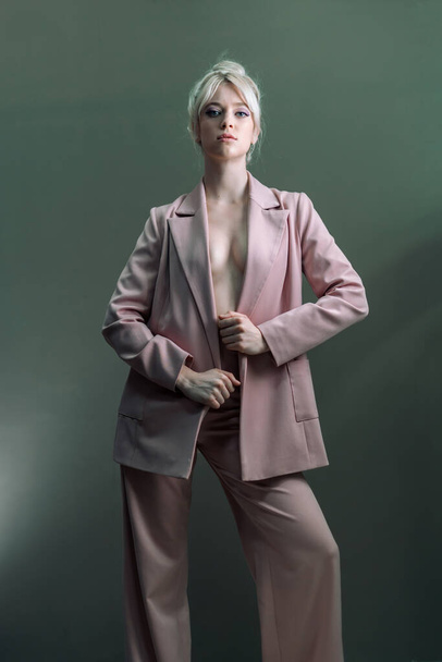 Sexy young blonde, a jacket dressed on a naked body. - Foto, afbeelding