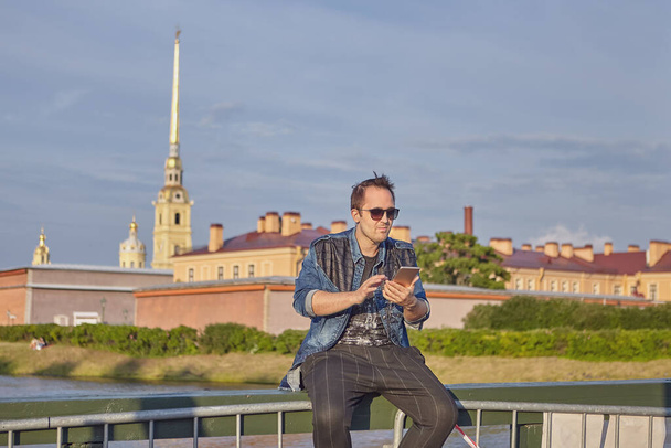 Caucasian tourist with phone in historical center of St.-Petersburg, Russia. - Φωτογραφία, εικόνα