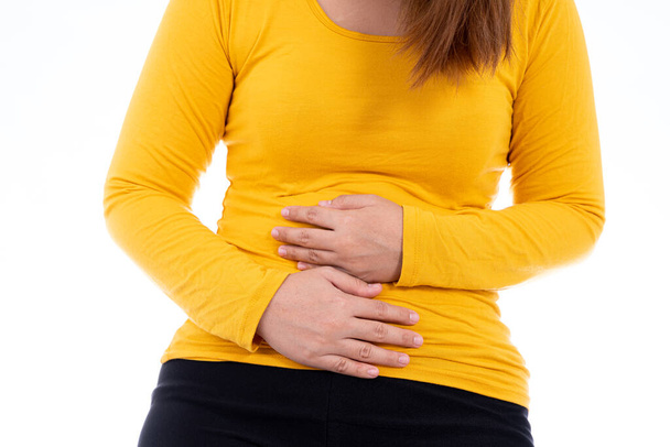 Woman suffering from stomach pain and injury isolated white background. Health care and medical concept. - Foto, Imagen