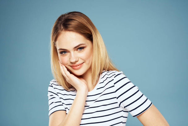 Blonde girl in striped t-shirt lifestyle blue background fun - Photo, Image