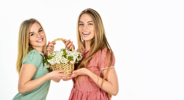 Happy womens day. Friendship and love. Women and flowers in basket. Rustic style girls gathering flowers together. Flowers shop. Natural fragrance. Girl carry flowers in basket. Floral shop - Zdjęcie, obraz