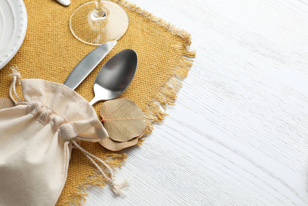 Autumn place setting with cutlery on white wooden table, closeup. Space for text - Foto, immagini