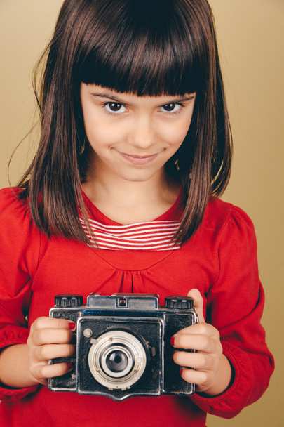 Little retro photographer with an old camera - 写真・画像