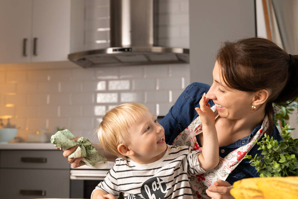 Beautiful mother and boy child preparing dinner. Happy family concept. - Photo, Image