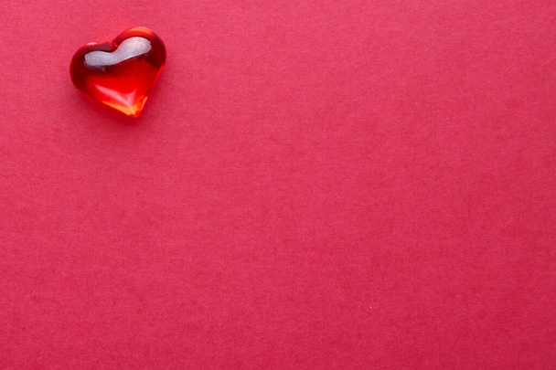 Red heart lollipop on red christmas background. - Foto, Imagen