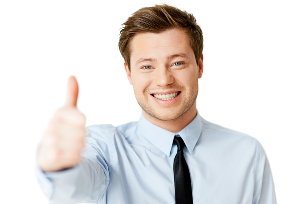 Man in shirt and tie showing his thumb up and smiling - Foto, imagen